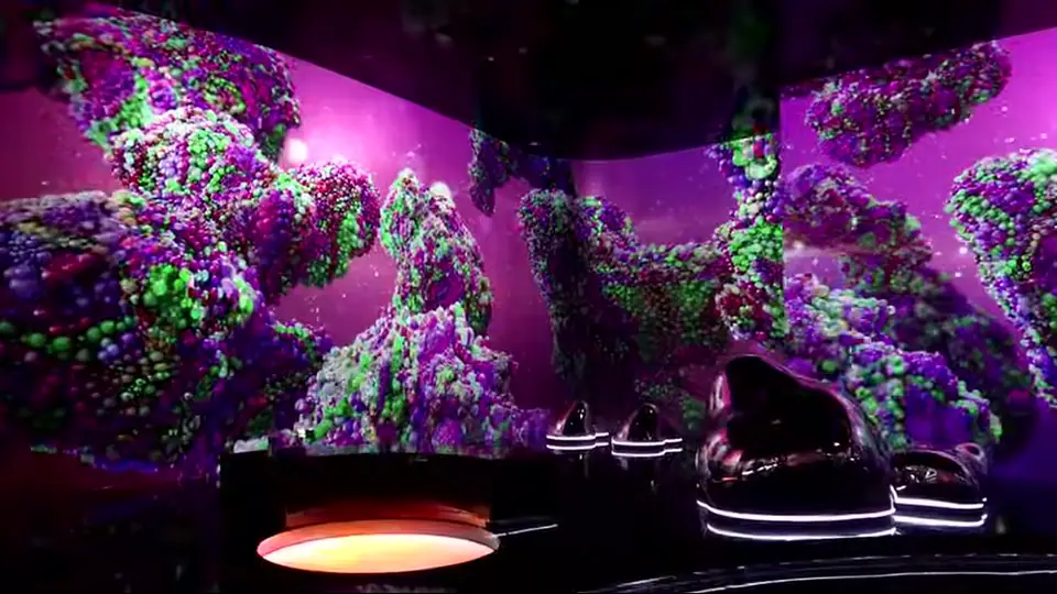 Digital landscape walls surround futuristic pod seats and a glowing circle.