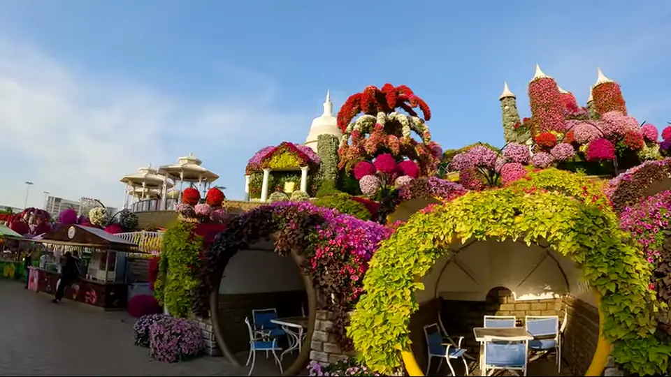 Floral hillside with circular seating alcoves, tables, and towers.