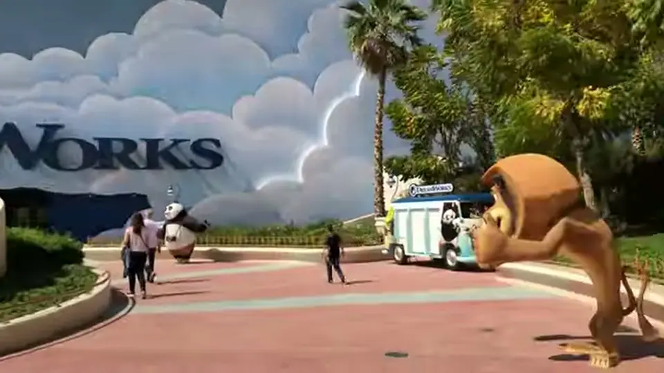 DreamWorks plaza with panda figure, lion statue, and themed truck.