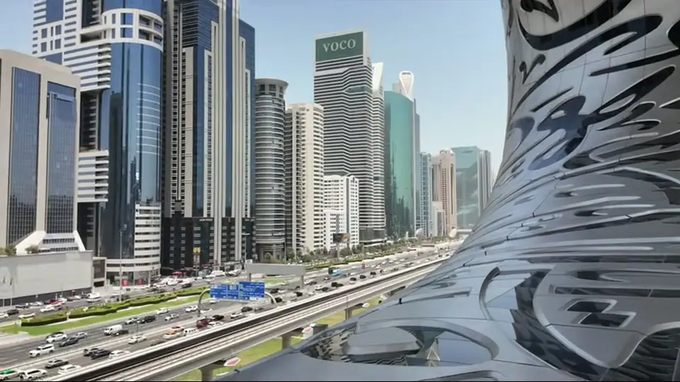 Daytime front view of the Museum of the Future with palms, lawn, and pool.