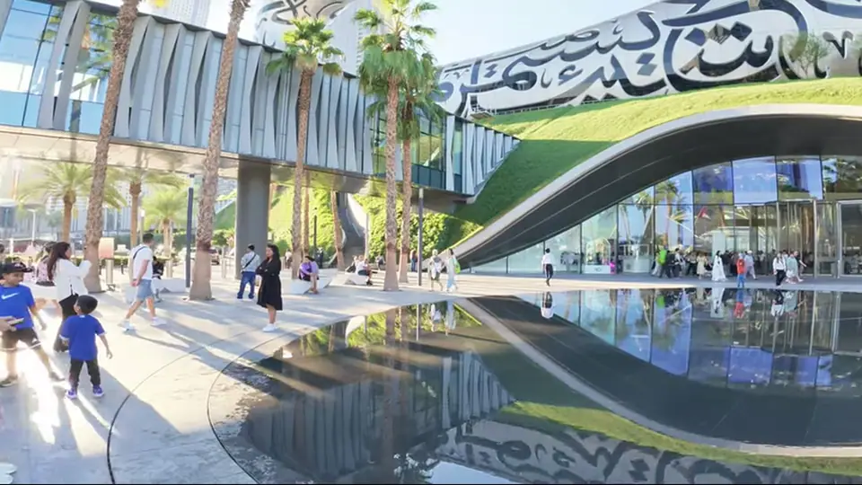 Museum exterior with Dubai skyline, metro line, and Sheikh Zayed Road.