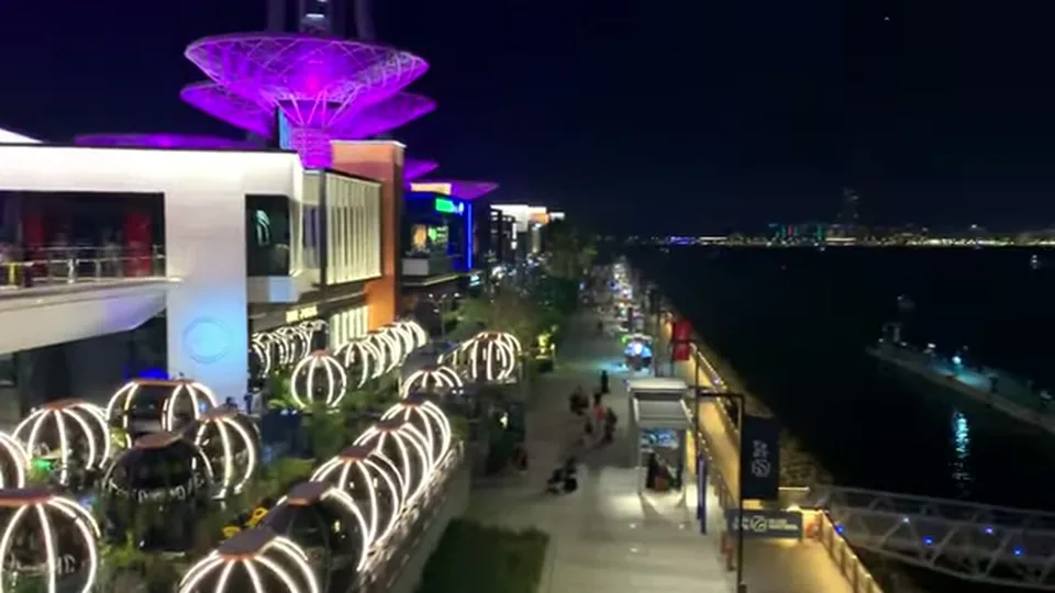 Bluewaters promenade with glowing dining pods and purple canopy lights