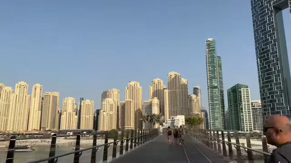 Pedestrian bridge from Bluewaters Island leading toward Dubai Marina skyline