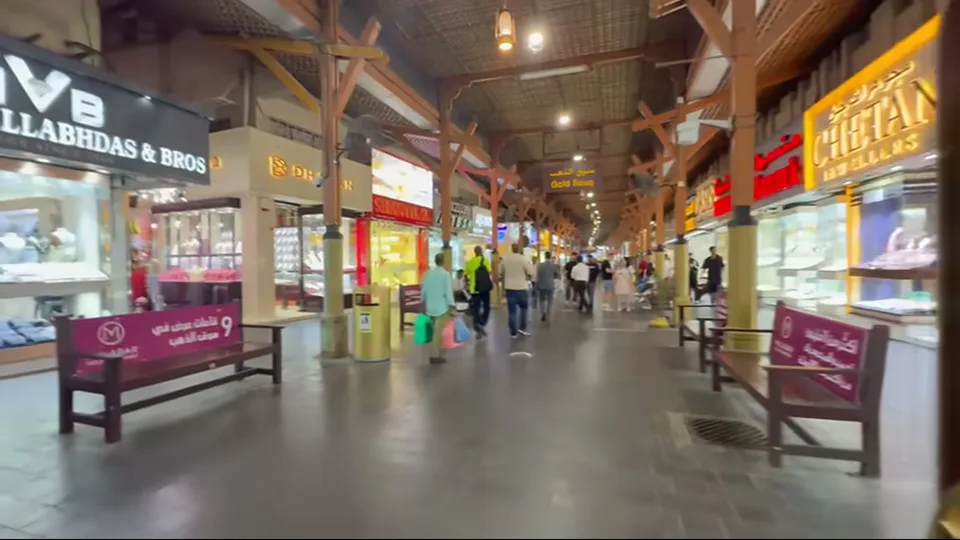 Main walkway inside Dubai Gold Souk with lit jewelry shops