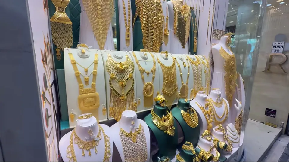 Gold jewelry sets filling a shop window in Dubai Gold Souk